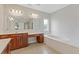 A primary bathroom features a double vanity, a soaking tub, and tile floors at 1516 Montauk Pt, Conyers, GA 30013