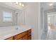 Bright bathroom featuring a single sink vanity and large mirror at 1516 Montauk Pt, Conyers, GA 30013