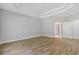 A bedroom features wood floors, neutral walls, and a tray ceiling at 1516 Montauk Pt, Conyers, GA 30013