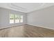 This bedroom has wood floors, large windows, and a tray ceiling at 1516 Montauk Pt, Conyers, GA 30013
