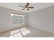 Sun-lit bedroom featuring neutral walls, carpet, and a large window at 1516 Montauk Pt, Conyers, GA 30013