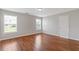 Bright bedroom featuring laminate flooring and natural light from two windows at 1516 Montauk Pt, Conyers, GA 30013