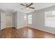 Bedroom with two windows, ceiling fan, and wood floor at 1516 Montauk Pt, Conyers, GA 30013