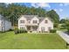 Charming two-story home with a well-manicured lawn and mature landscaping at 1516 Montauk Pt, Conyers, GA 30013