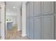 Hallway with hard wood floors and blue cabinets at 1516 Montauk Pt, Conyers, GA 30013