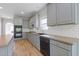 A kitchen features gray cabinets, stainless steel appliances, subway tile backsplash, and wood-look floors at 1516 Montauk Pt, Conyers, GA 30013