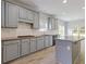 Bright kitchen with hardwood floors, a center island, gray cabinets, and a subway tile backsplash at 1516 Montauk Pt, Conyers, GA 30013