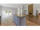 Bright kitchen with a center island and open floor plan to the living room and stone fireplace at 1516 Montauk Pt, Conyers, GA 30013