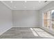 A bright room with hardwood floors, white trim, crown molding, and a large window at 1516 Montauk Pt, Conyers, GA 30013