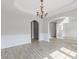 Spacious living room featuring hardwood floors, archways, and a decorative chandelier at 1516 Montauk Pt, Conyers, GA 30013