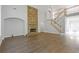 A living room features a stone fireplace, wood floors, and stairs leading to the second floor at 1516 Montauk Pt, Conyers, GA 30013