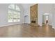 A spacious living room features a stone fireplace and large windows with plenty of natural light at 1516 Montauk Pt, Conyers, GA 30013
