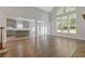 A living room is open to the kitchen and features large windows with plenty of natural light at 1516 Montauk Pt, Conyers, GA 30013