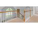 View of the home's staircase with wooden railing at 1516 Montauk Pt, Conyers, GA 30013
