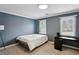 Bedroom features neutral carpet, blue walls, and natural light from two windows at 265 Winding River Dr # G, Sandy Springs, GA 30350