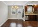 Charming dining area with hardwood floors, stylish lighting, and view to kitchen at 265 Winding River Dr # G, Sandy Springs, GA 30350