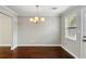 Bright dining area boasting hardwood floors, stylish lighting, and natural light at 265 Winding River Dr # G, Sandy Springs, GA 30350