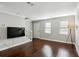 Modern living room featuring hardwood floors, staircase, and abundant natural light at 265 Winding River Dr # G, Sandy Springs, GA 30350