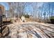 Spacious backyard stone patio features an outdoor kitchen and basketball hoop at 3290 Coachmans Ne Way, Roswell, GA 30075