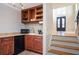 This bar area includes wooden cabinets, a small sink, a countertop, a wine rack, and a microwave perfect for entertaining at 3290 Coachmans Ne Way, Roswell, GA 30075