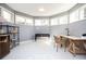 The bonus room has light gray walls, white tile floors, natural lighting, and ample space for a home office or activity area at 3290 Coachmans Ne Way, Roswell, GA 30075