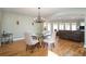 Elegant dining room with a glass table, chandelier, and hardwood floors at 3290 Coachmans Ne Way, Roswell, GA 30075