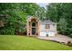 Beautiful brick home with a stone pillar entryway and a well-manicured lawn and mature tree coverage at 3290 Coachmans Ne Way, Roswell, GA 30075