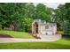Charming home with brick and stone accents, lush landscaping, and a two-car garage at 3290 Coachmans Ne Way, Roswell, GA 30075