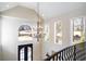 Grand foyer with high ceilings, a chandelier, and large windows at 3290 Coachmans Ne Way, Roswell, GA 30075