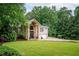 Elegant home with stone facade, arched entry, and a two-car garage at 3290 Coachmans Ne Way, Roswell, GA 30075