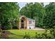 Beautiful brick house with mature trees and a well-manicured lawn at 3290 Coachmans Ne Way, Roswell, GA 30075