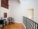 This landing area features hardwood floors, and provides architectural interest with rustic, wood-trimmed windows and railings at 3290 Coachmans Ne Way, Roswell, GA 30075