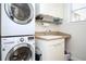 Bright laundry room features a stacked washer/dryer and built-in shelving at 3290 Coachmans Ne Way, Roswell, GA 30075