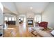 Spacious living room featuring a stone fireplace, hardwood floors, and abundant natural light at 3290 Coachmans Ne Way, Roswell, GA 30075