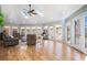 Open living room with hardwood floors, skylights and doors to an outdoor deck and fenced-in yard at 3290 Coachmans Ne Way, Roswell, GA 30075