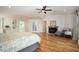 Spacious main bedroom with hardwood floors, a fireplace, and a ceiling fan at 3290 Coachmans Ne Way, Roswell, GA 30075