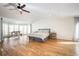 Spacious main bedroom with hardwood floors, ceiling fan, and bay window with plenty of natural light at 3290 Coachmans Ne Way, Roswell, GA 30075
