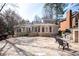 A sprawling flagstone patio overlooks the home's extended sunroom and outdoor cooking area at 3290 Coachmans Way Ne Way, Roswell, GA 30075