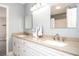 Bright bathroom featuring double sink vanity with tan countertops, modern fixtures, and a large mirror at 3290 Coachmans Way Ne Way, Roswell, GA 30075