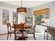 Breakfast nook features a wooden table, stylish lighting, and natural light from the door and window at 3290 Coachmans Way Ne Way, Roswell, GA 30075