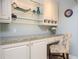 Elegant dry bar area with granite countertops, custom cabinets, and glass shelving for displaying glassware at 3290 Coachmans Way Ne Way, Roswell, GA 30075