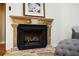 Living room fireplace featuring a stone surround and hearth with a decorative print above the mantel at 3290 Coachmans Ne Way, Roswell, GA 30075