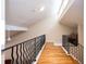 Hallway with wood floors, railing, and high ceilings, with a view to the downstairs at 3290 Coachmans Way Ne Way, Roswell, GA 30075