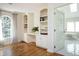 Bright home office with built-in bookshelves and desk, with a view to the luxurious bathroom at 3290 Coachmans Way Ne Way, Roswell, GA 30075