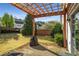 Spacious backyard featuring a pergola-covered patio and well-manicured lawn at 5035 Foxberry Ln, Roswell, GA 30075