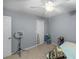 Bedroom with carpet, a ceiling fan, and neutral decor, offering a blank canvas at 5035 Foxberry Ln, Roswell, GA 30075