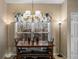 Cozy dining area with a wooden table, bench seating, a floral valance, and bright natural light at 5035 Foxberry Ln, Roswell, GA 30075