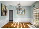 Elegant dining room with hardwood floors, chandelier, and easy access to the kitchen and backyard at 5035 Foxberry Ln, Roswell, GA 30075