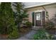 Inviting front entrance with decorative accents, lush greenery, and a charming 'Welcome Home' sign at 5035 Foxberry Ln, Roswell, GA 30075