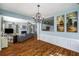 Spacious living room open to dining area, featuring hardwood floors and a cozy fireplace at 5035 Foxberry Ln, Roswell, GA 30075